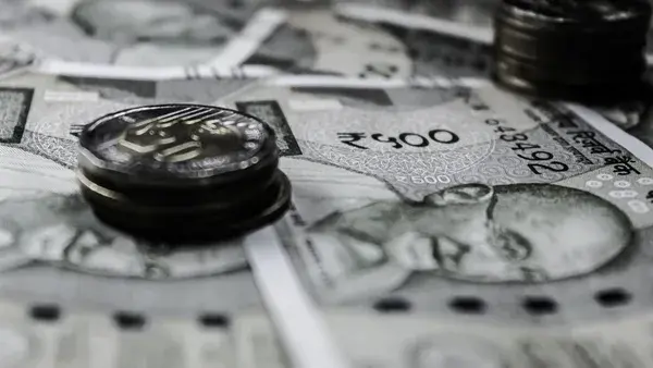 A detailed close-up of Indian currency notes and coins, highlighting financial themes.