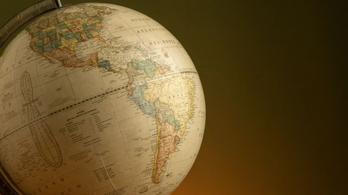 A vintage globe highlighting North and South America, set against a warm background.