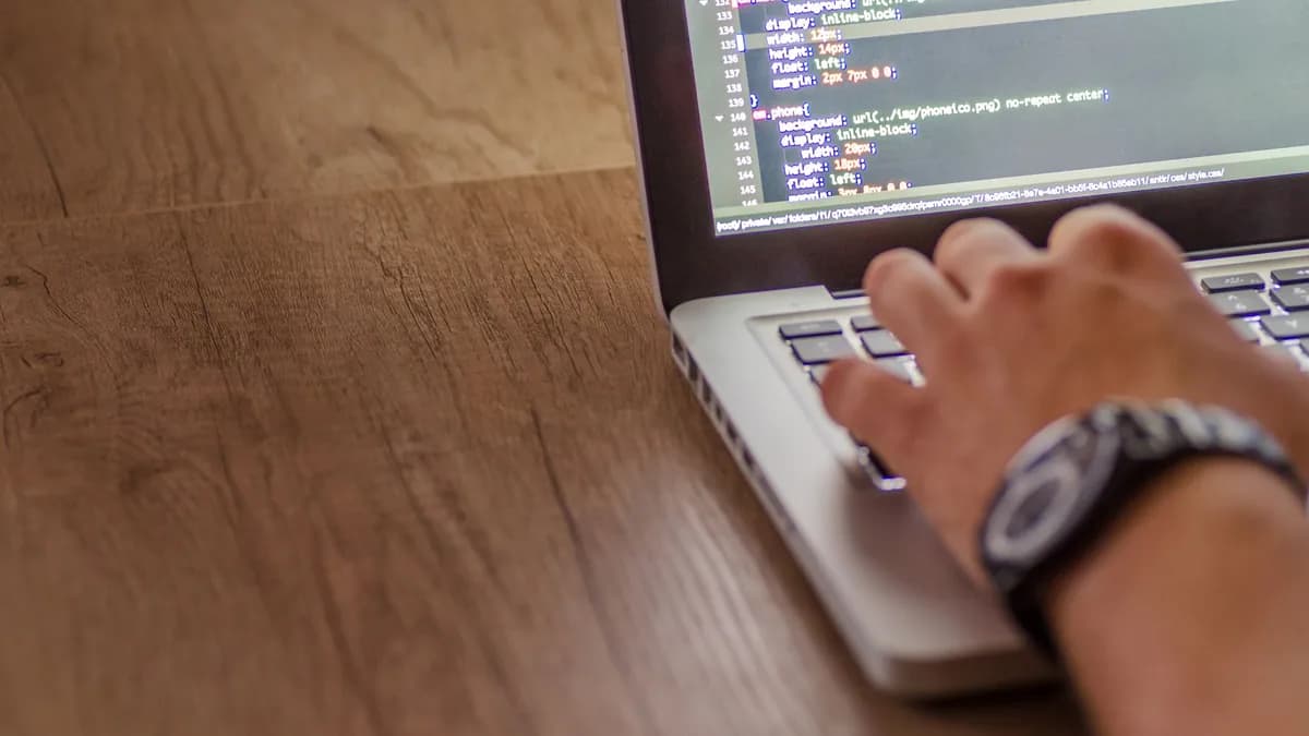 Close-up of a person coding on a laptop, showcasing web development and programming concepts.