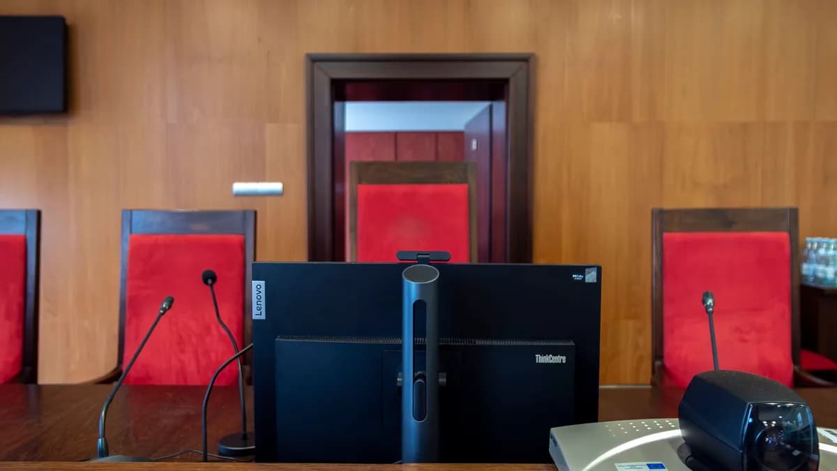 Modern courtroom interior in Wrocław, Poland featuring judge's bench and red seating.
