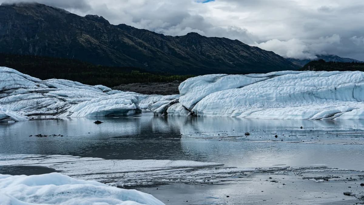 Pristine glacier landscape with icy lake in a remote mountainous region.