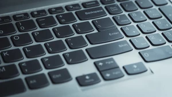 Detailed view of a laptop keyboard with focus on keys. Ideal for tech content.