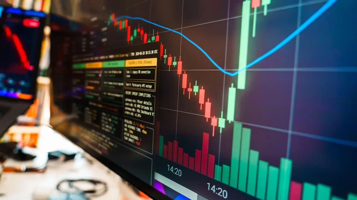 Close-up of a financial monitor displaying real-time cryptocurrency data and charts in a modern office.