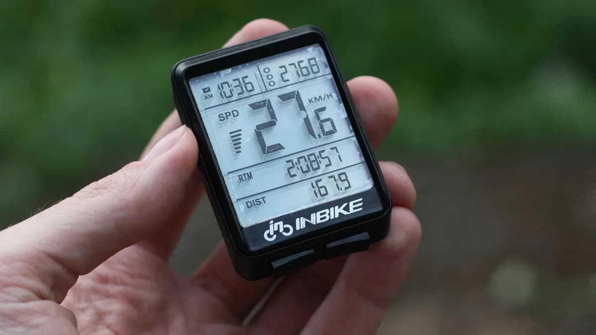 Detailed shot of digital bike speedometer displaying speed, distance, and time.