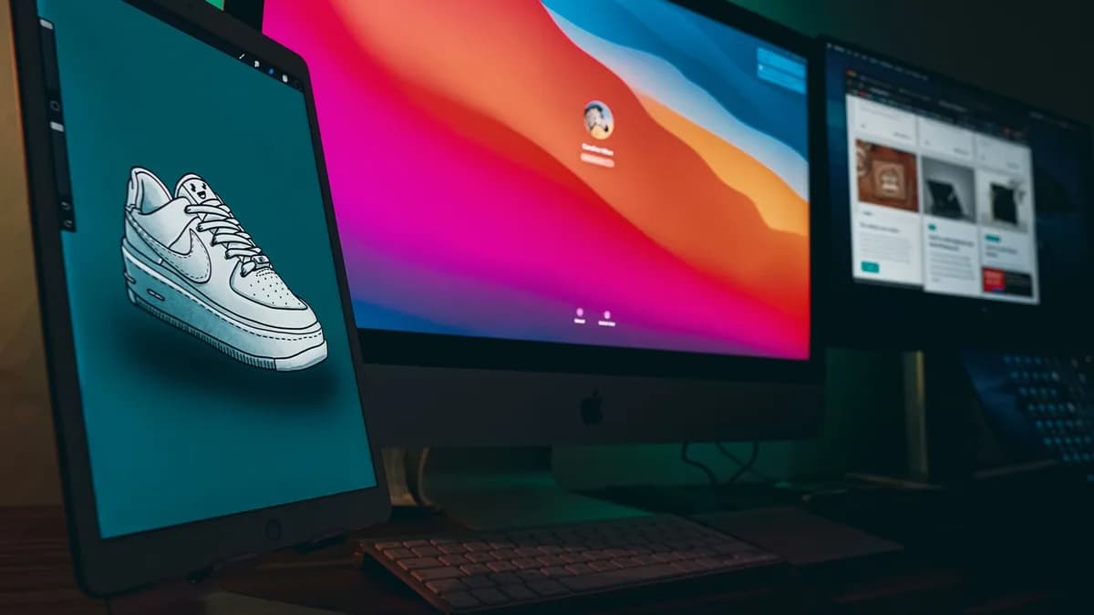A digital workspace featuring Apple devices with Nike sneaker design displayed on a tablet.