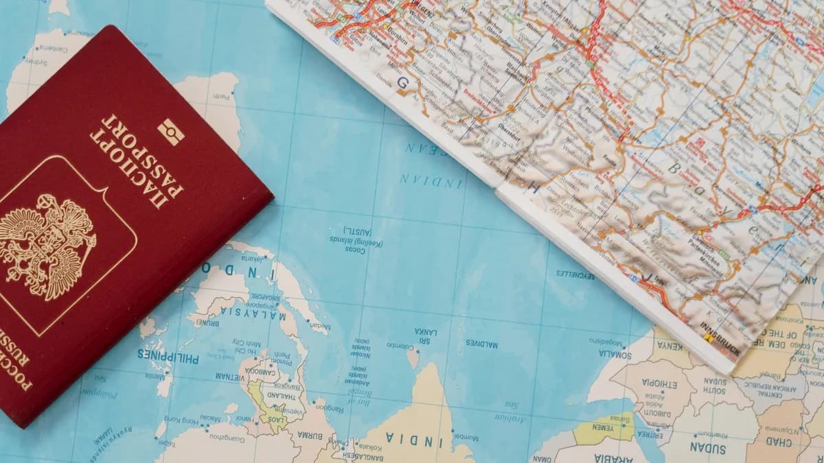 Flat lay of a passport and map, symbolizing travel adventure and exploration.