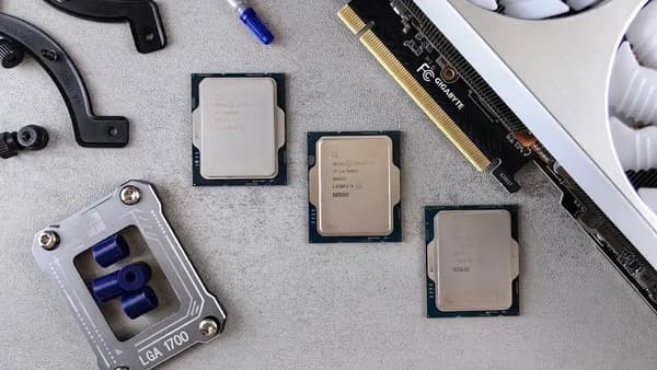 Overhead view of CPUs, graphics card, and mounting equipment on gray background, emphasizing modern technology.