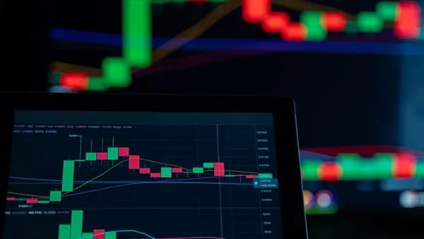 Close-up of a digital trading chart with candlestick patterns and market analysis in a dark setting.