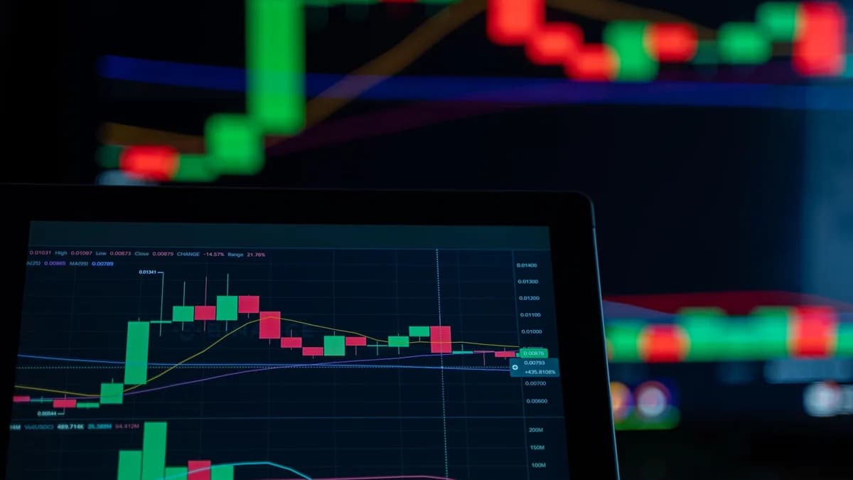 Close-up of a digital trading chart with candlestick patterns and market analysis in a dark setting.