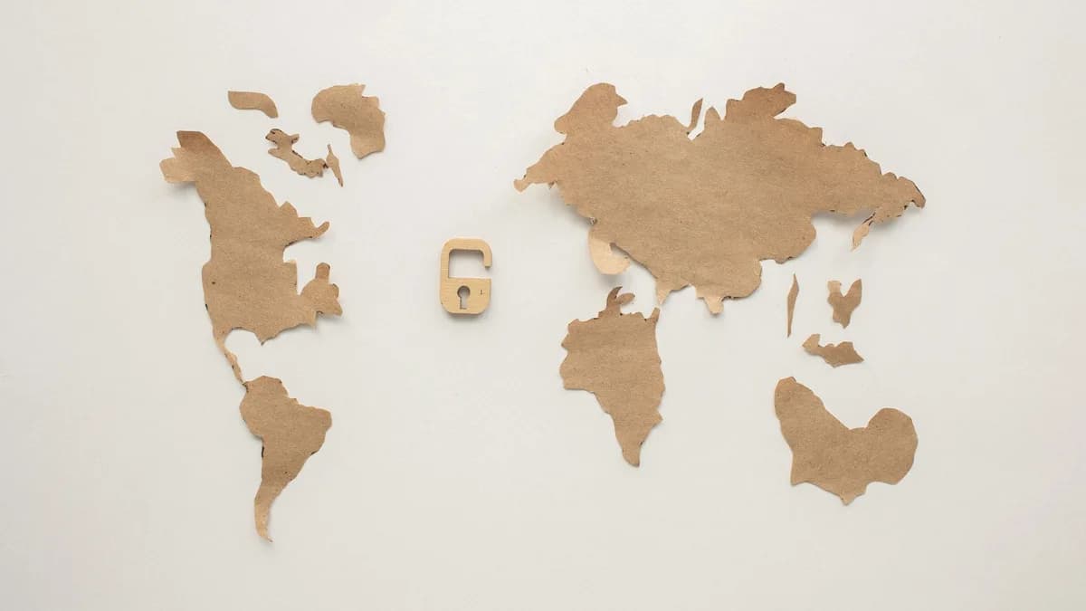 An artistic flat lay of a world map cutout accompanied by a padlock, symbolizing security.