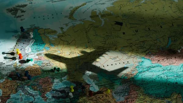 Shadow of an airplane on a map of Europe, highlighting travel and exploration concepts.